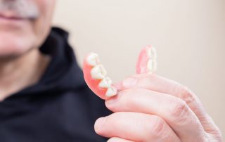 Man holding dentures