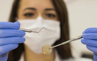 Dentist holding dental tools