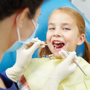 child getting teeth cleaned at the dentist