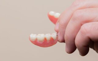 person holding dentures