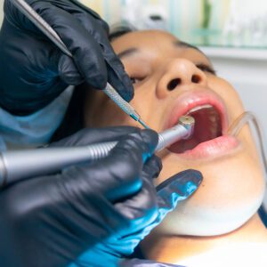 woman getting a dental cleaning at dentist