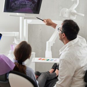 dentist reviewing dental scans with patient