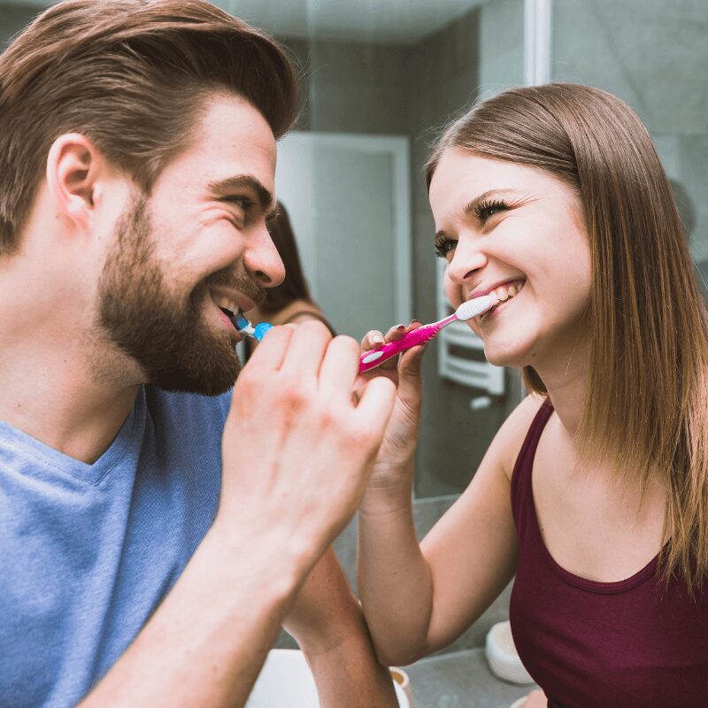 happy couple tending to oral health care