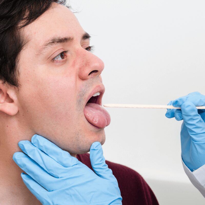 oral health examination with tongue depressor