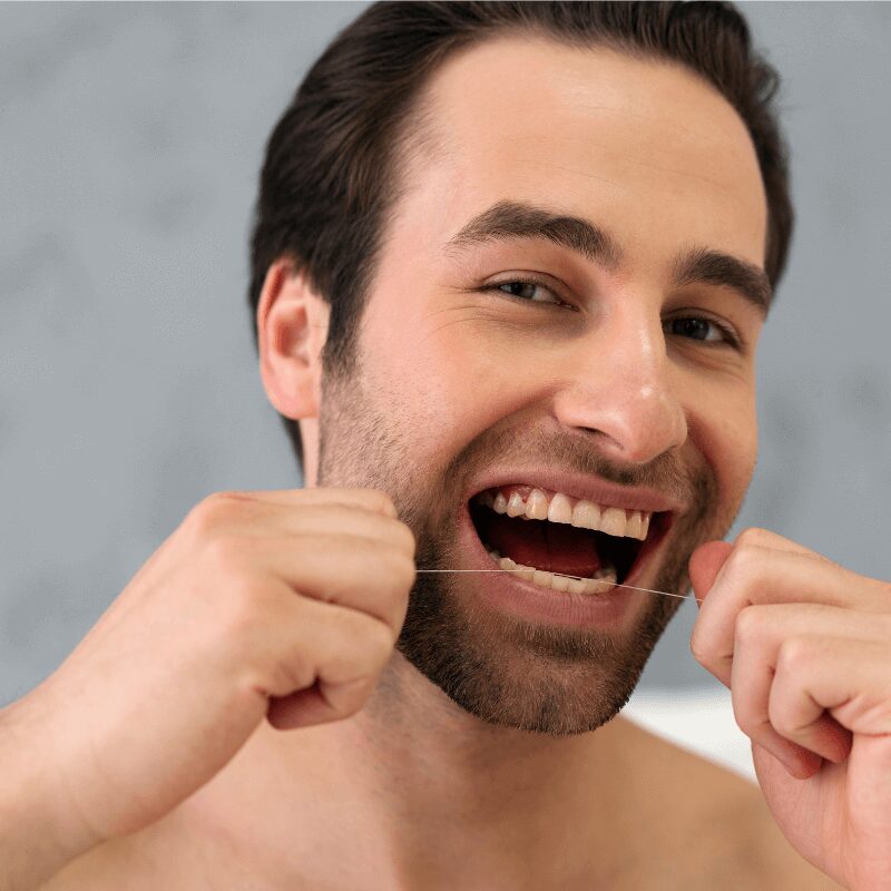 man flossing teeth carefully